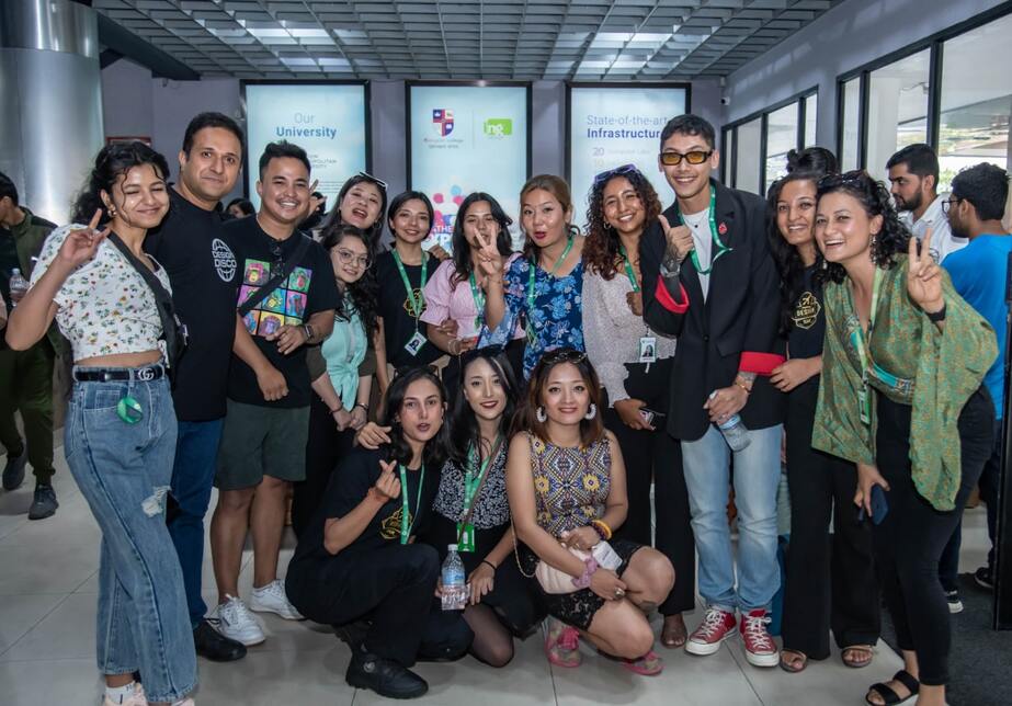 The organizers and participants pose for a group photo outside the auditorium