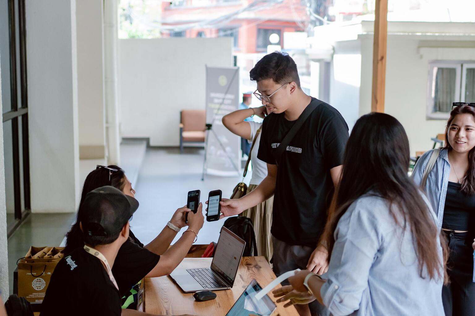 A participant being checked in using QR code scan by event volunteers